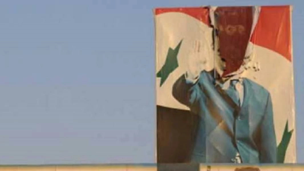 شبان يمزّقون صورة لبشار الأسد وسط بلدة ناحتة في درعا 