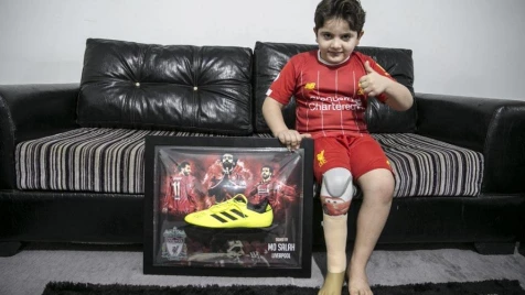 Syrian child receives football shirt, boot signed by Liverpool’s Mohamed Salah