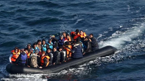 Rescuers watch 31 refugees drown in the Aegean Sea fearing charges with people smuggling